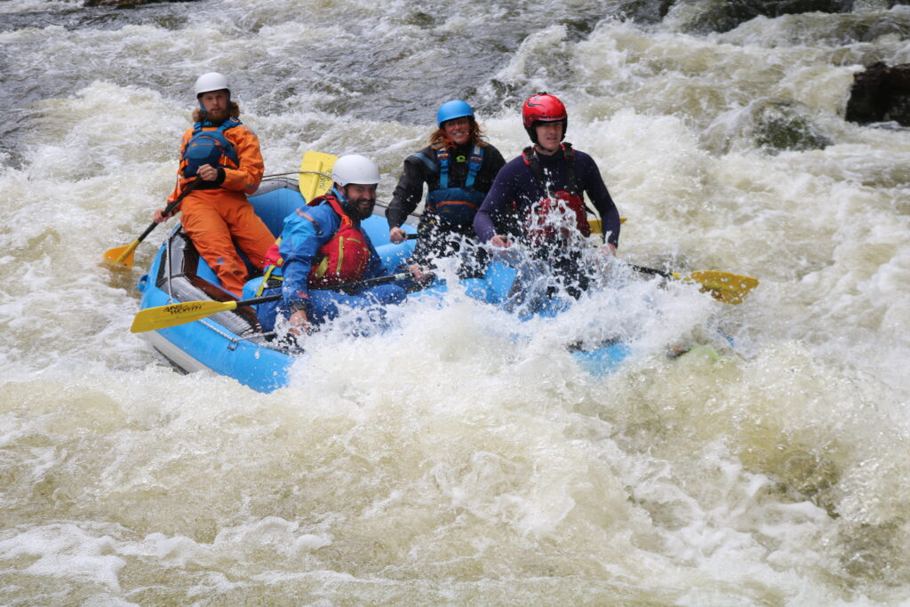 A group of people enjoying an Active Outdoor Pursuits white water rafting adventure