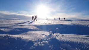 A group of people taking part in Winter Mountain Skills training in the Cairngorms, Scotland with Active Outdoor Pursuits.