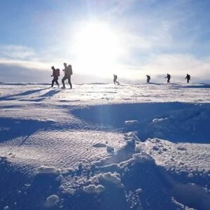 A group of people taking part in Winter Mountain Skills training in the Cairngorms, Scotland with Active Outdoor Pursuits.