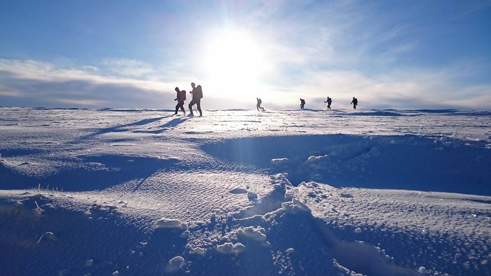 A group of people taking part in Winter Mountain Skills training in the Cairngorms, Scotland with Active Outdoor Pursuits.