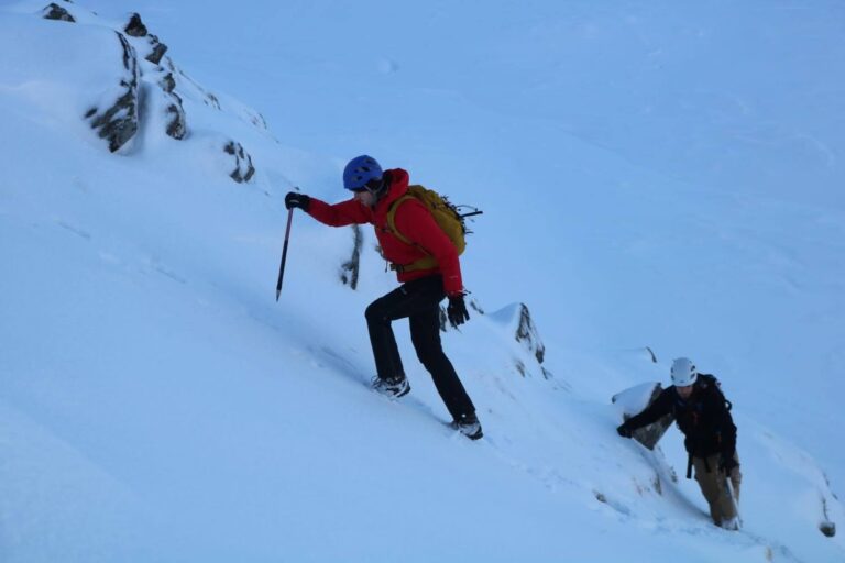 A group of people taking part in Winter Mountain Skills training in the Cairngorms, Scotland with Active Outdoor Pursuits.