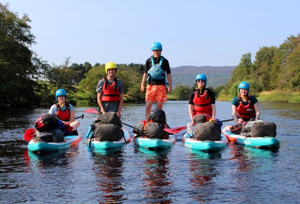 An image of Duke of Edinburgh expedition participants on Stand Up Paddleboards