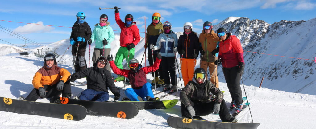 A group of people taking part in snowboarding and skiing with Active Outdoor Pursuits