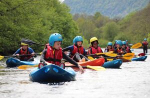 A group of young people kayaking in the Cairngorms